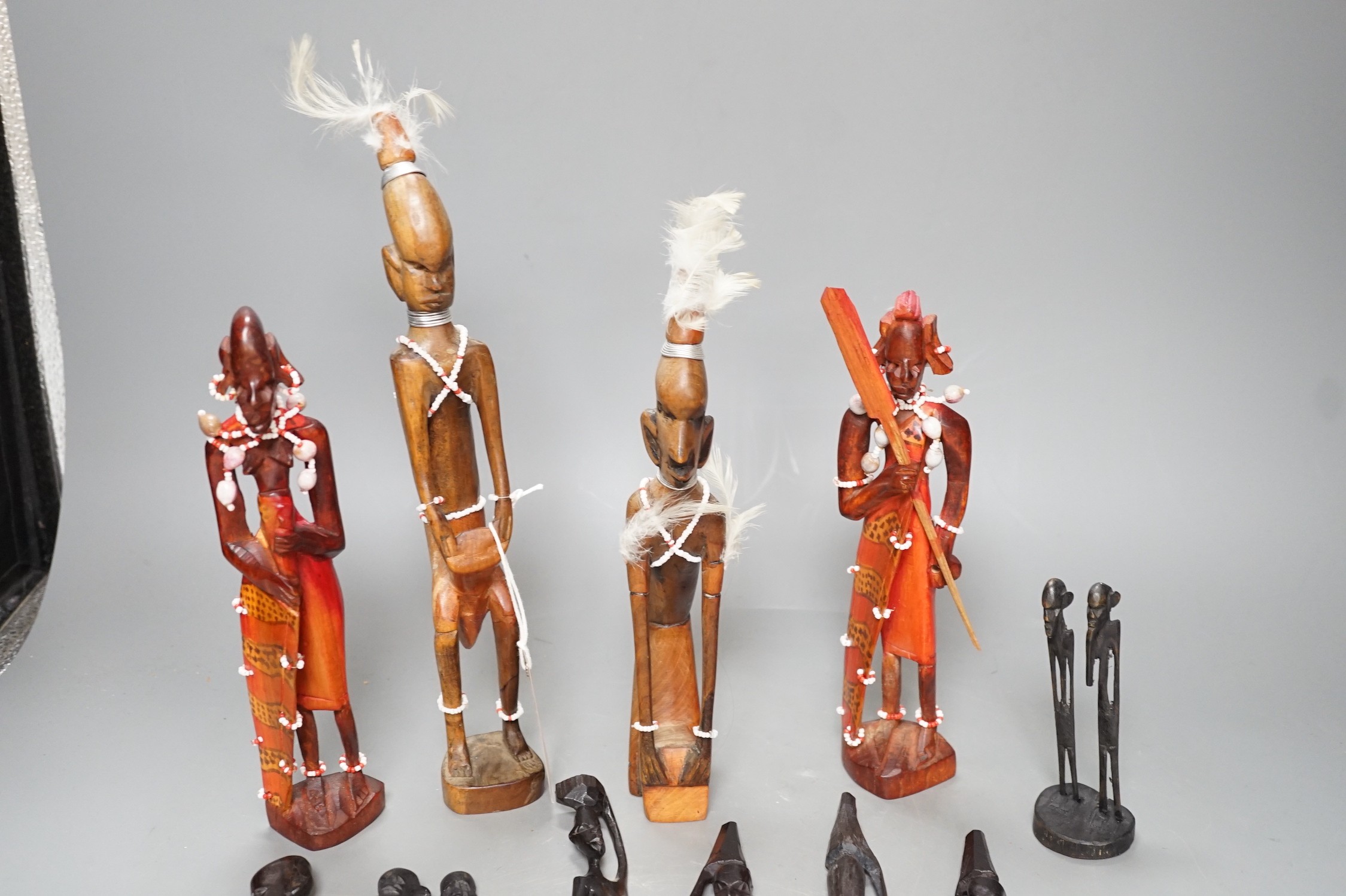 12 African carved wood stick figures, tallest 38cms high